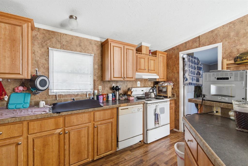 406 Hilltop Meadows Court Springtown, TX 76082 - Photo 24 of 33 a kitchen with stainless steel appliances a sink stove and cabinets