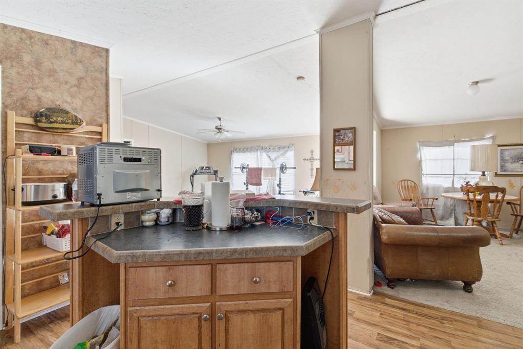 406 Hilltop Meadows Court Springtown, TX 76082 - Photo 33 of 33 a kitchen with stainless steel appliances granite countertop a sink and cabinets