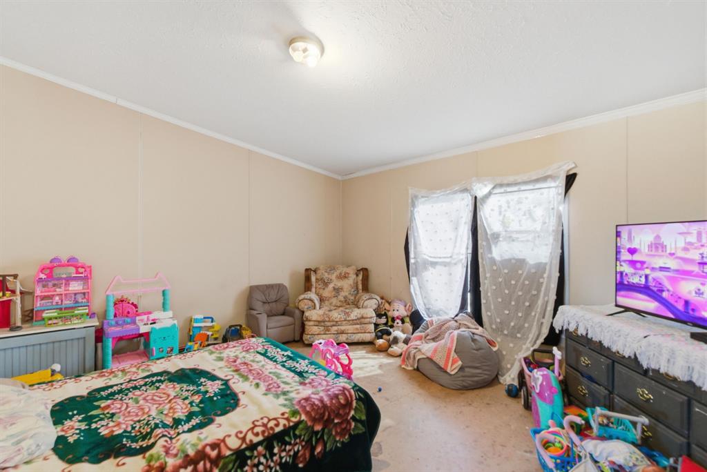 406 Hilltop Meadows Court Springtown, TX 76082 - Photo 27 of 33 a bedroom with bed and a tv