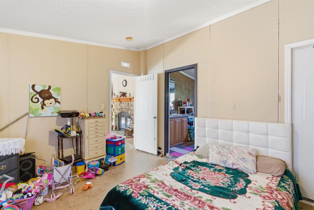 406 Hilltop Meadows Court Springtown, TX 76082 - Photo 28 of 33 a bedroom with bed and a window