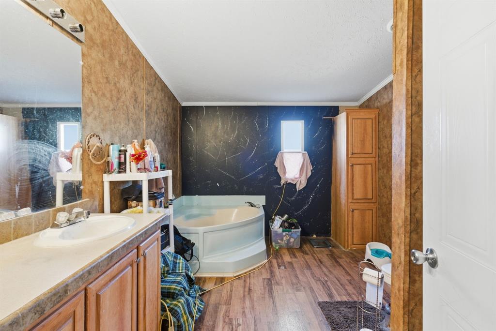 406 Hilltop Meadows Court Springtown, TX 76082 - Photo 29 of 33 a view of a kitchen area with furniture and wooden floor