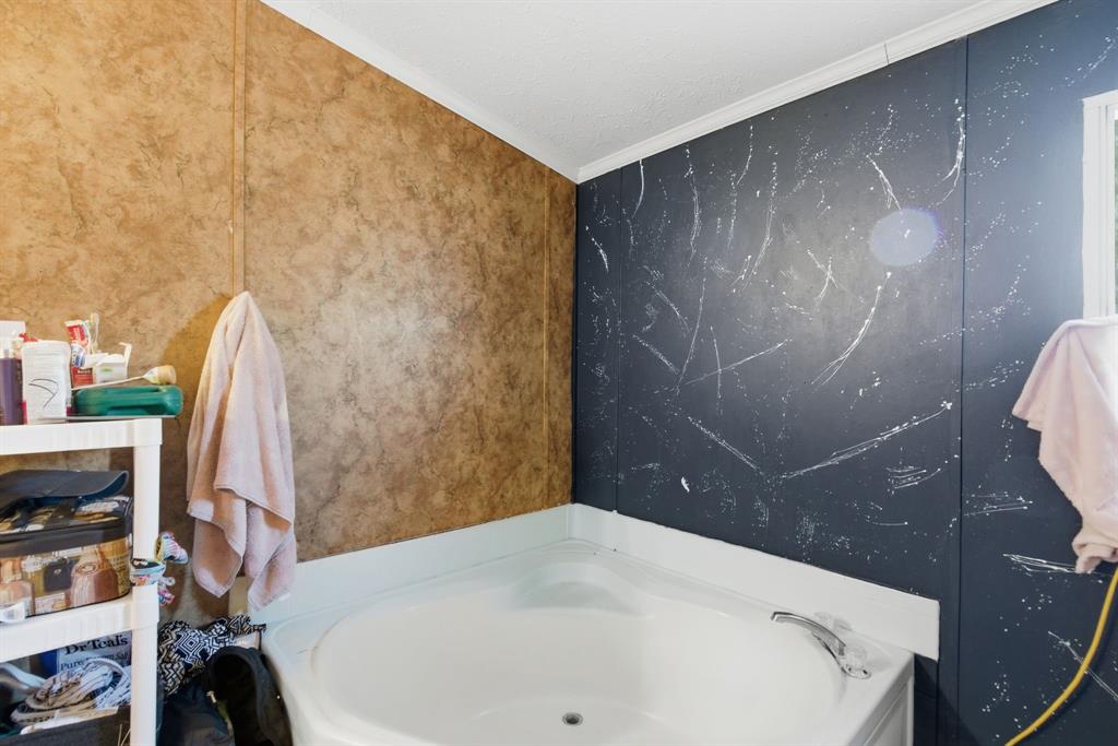 406 Hilltop Meadows Court Springtown, TX 76082 - Photo 32 of 33 a bathroom with a sink and a mirror