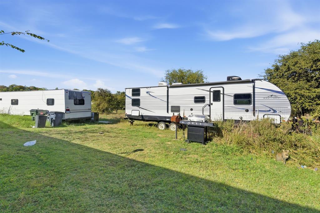 406 Hilltop Meadows Court Springtown, TX 76082 - Photo 4 of 33 a house view with a garden space