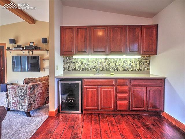 10380 Link Road Fountain, CO 80817 - Photo 21 of 35 Entertainment room wet bar with wine fridge.