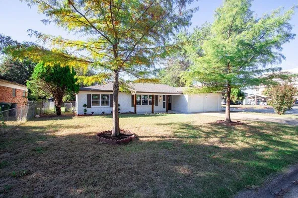a house with trees in the background
