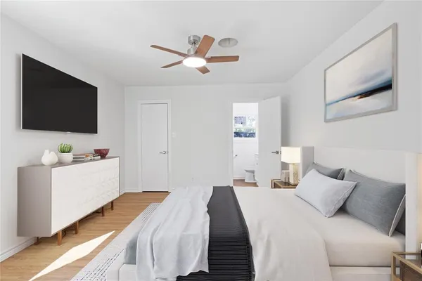 a bedroom with a bed and a flat screen tv