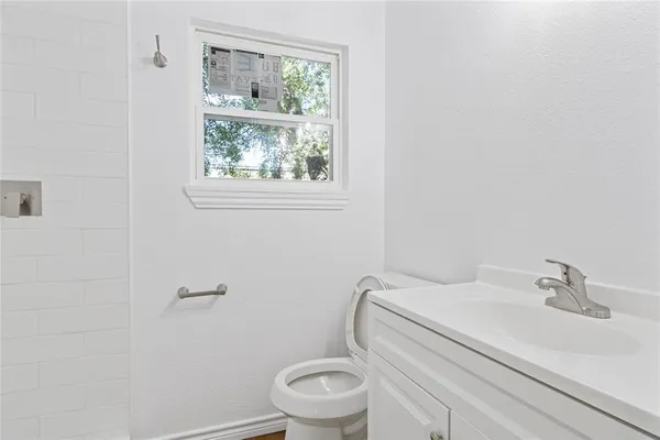 a white toilet sitting next to a bathroom sink