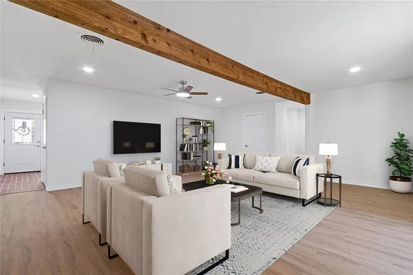 a living room with furniture and a flat screen tv