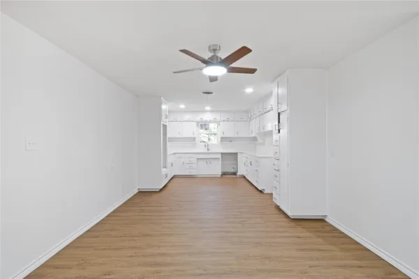 a view of a kitchen with a sink and wooden floor