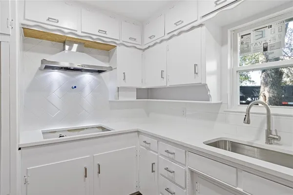 a kitchen with a sink and a refrigerator