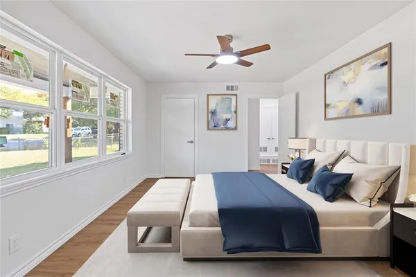 a bedroom with a bed and wooden floor