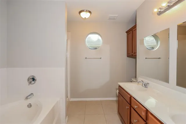 a bathroom with a sink a mirror and a bathtub