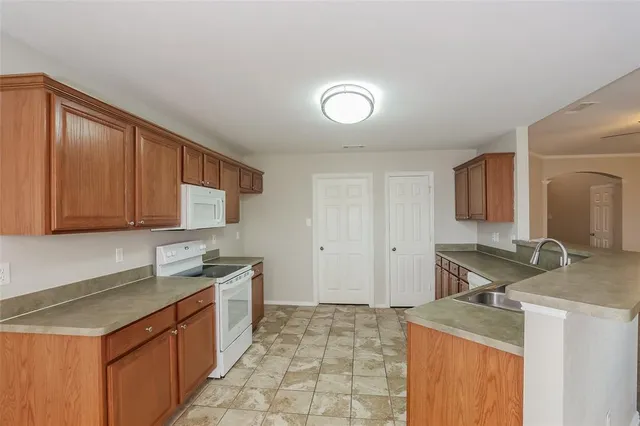 a kitchen that has a sink and a stove in it