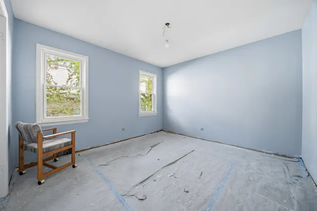 a view of room with window and a ceiling fan