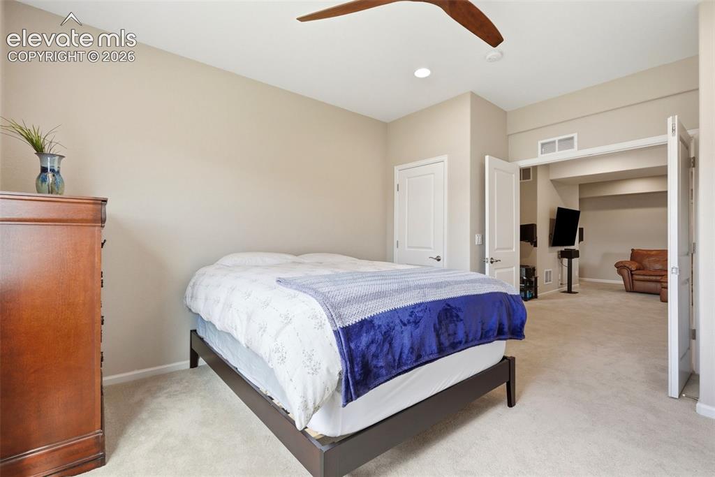1394 Promontory Bluff View Colorado Springs, CO 80921 - Photo 43 of 47 a spacious bedroom with a bed and a cabinets