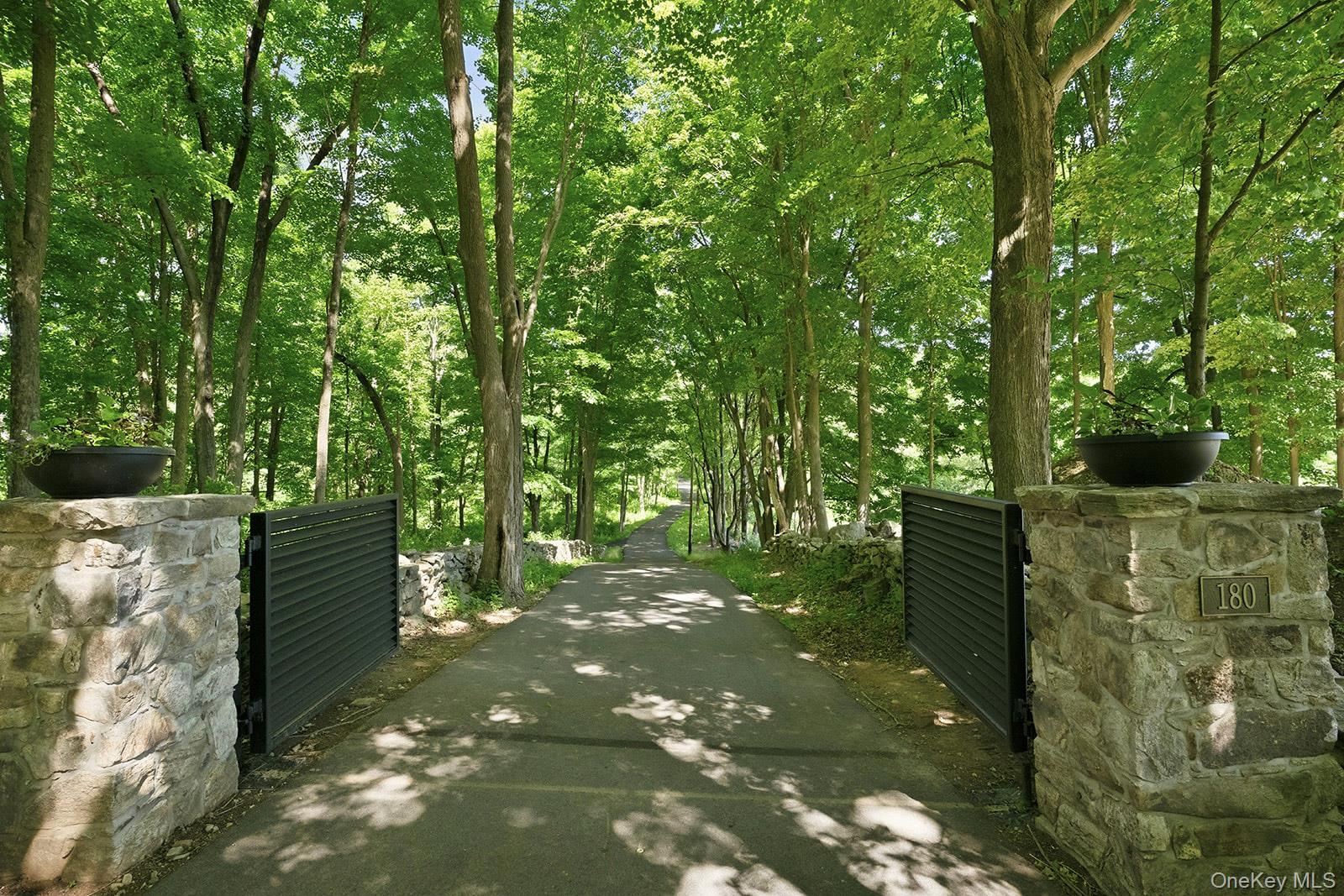 180 Dean Road Carmel, NY 10512 - Photo 50 of 50 Automated steelgated ½ mile long paved driveway provides both a secure entrance and a meandering romanticdrive to the interior compound