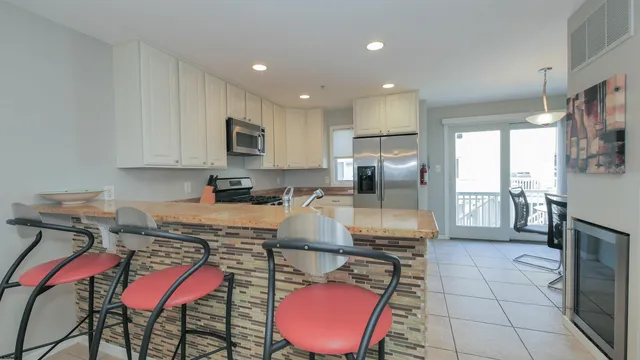 a kitchen with stainless steel appliances granite countertop a refrigerator and microwave