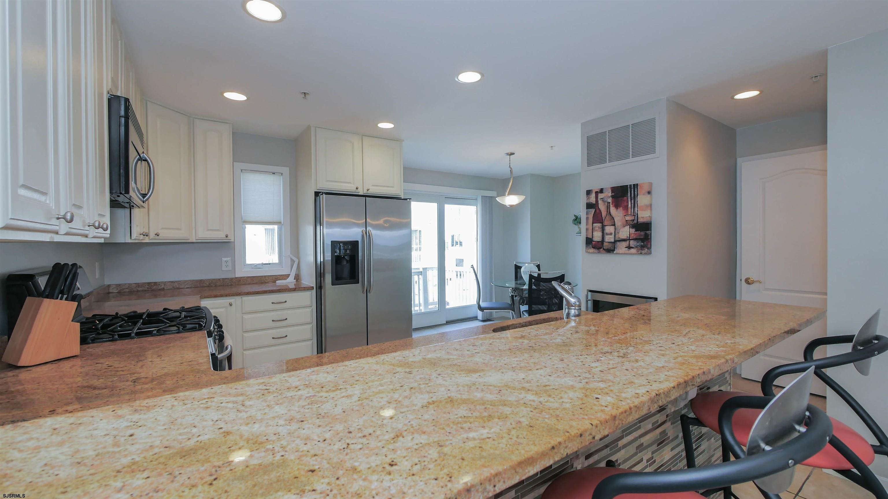 137 South Berkley Square, Unit B Atlantic City, NJ 08401 - Photo 17 of 42 a kitchen with stainless steel appliances granite countertop a refrigerator and microwave