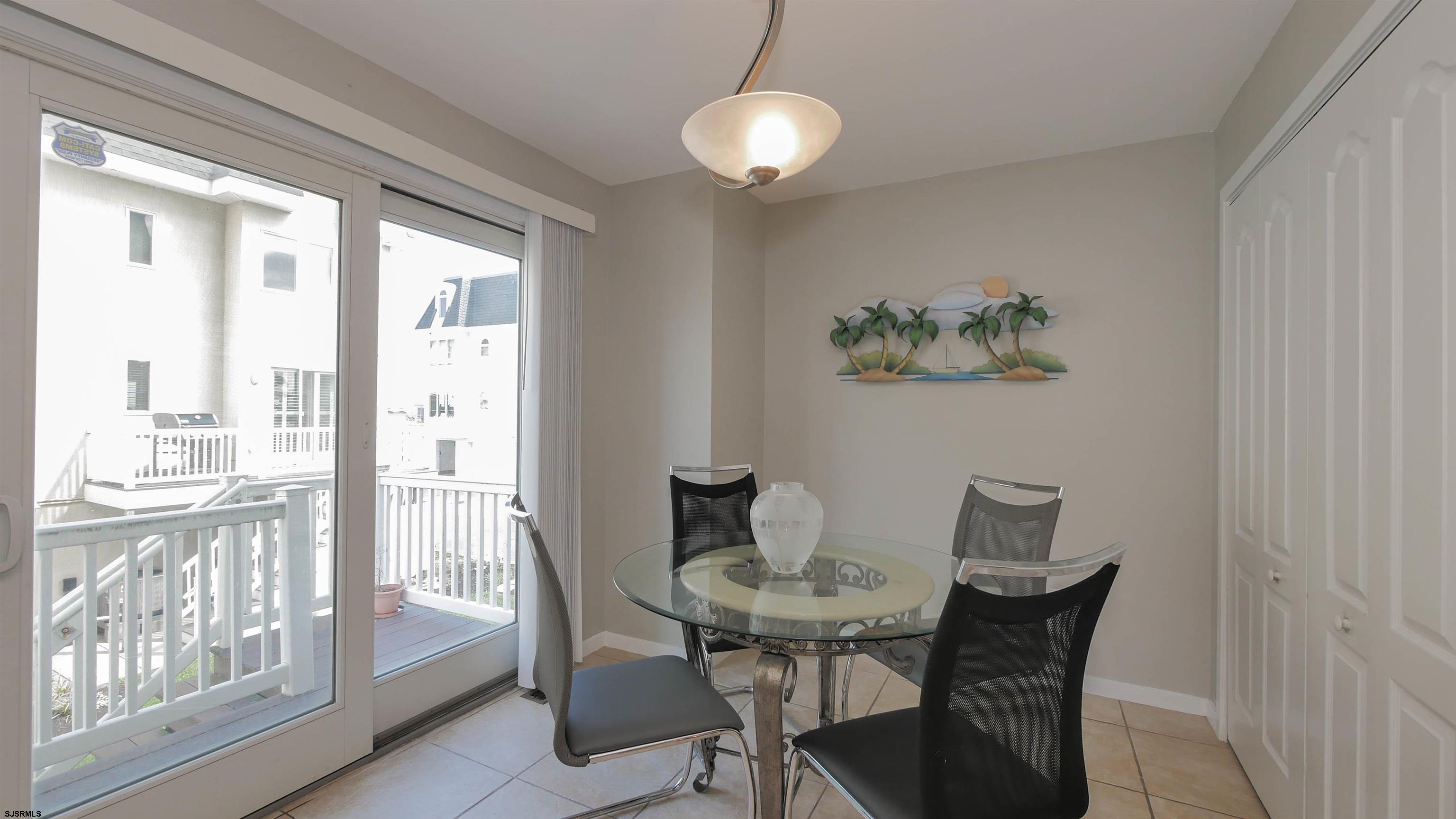137 South Berkley Square, Unit B Atlantic City, NJ 08401 - Photo 19 of 42 a view of a dining room with furniture wooden floor and a chandelier