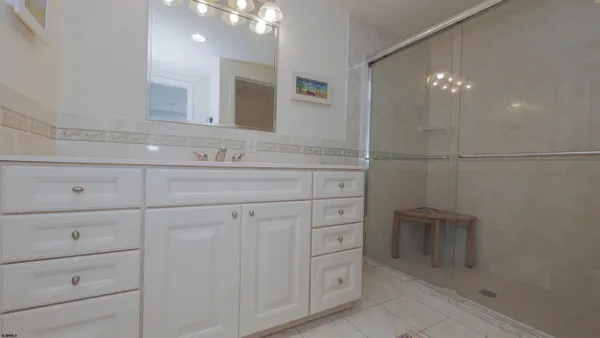 a bedroom with a bed lamp closet and large window