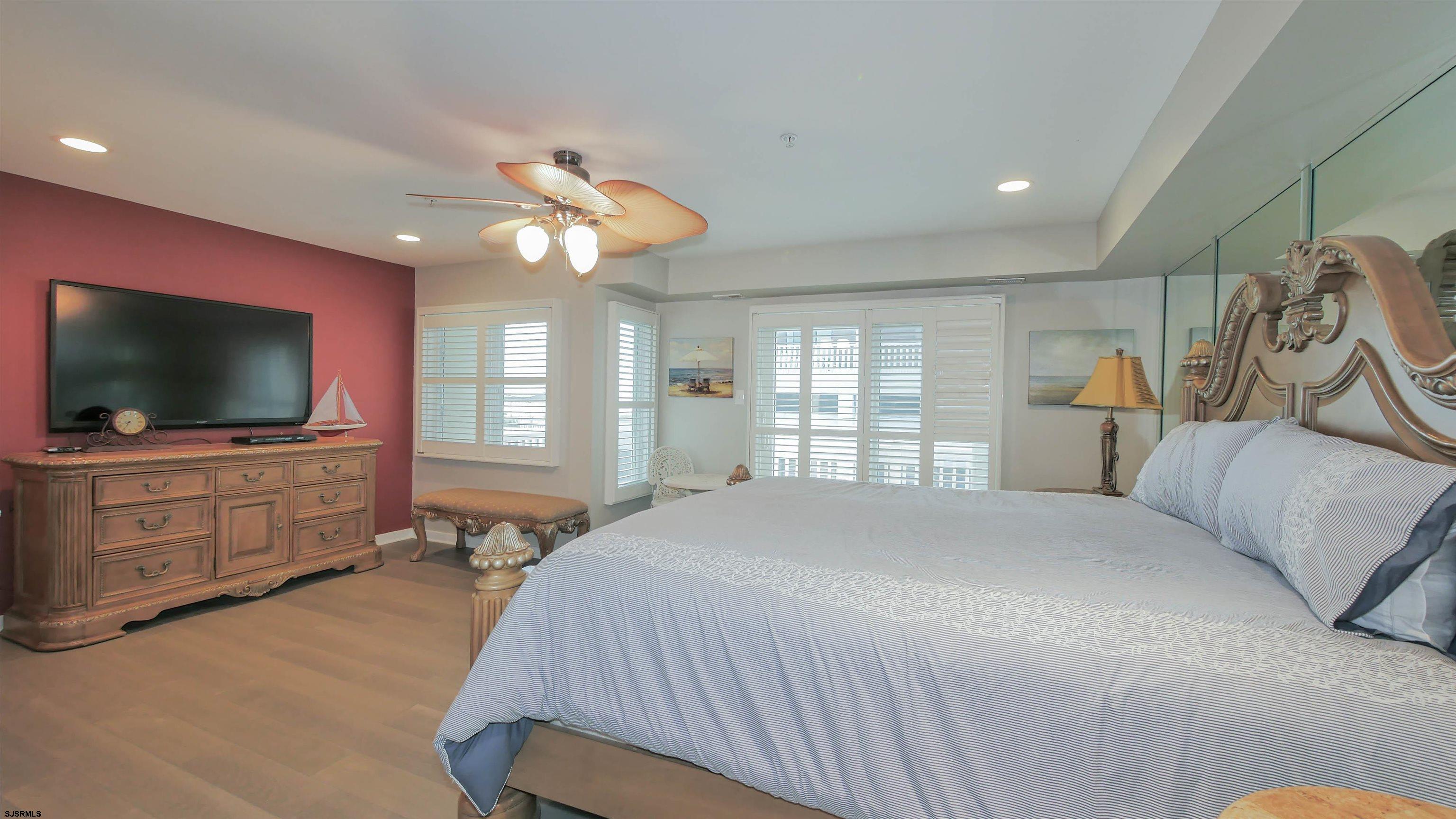 137 South Berkley Square, Unit B Atlantic City, NJ 08401 - Photo 23 of 42 a bedroom with a bed and a flat screen tv on dresser