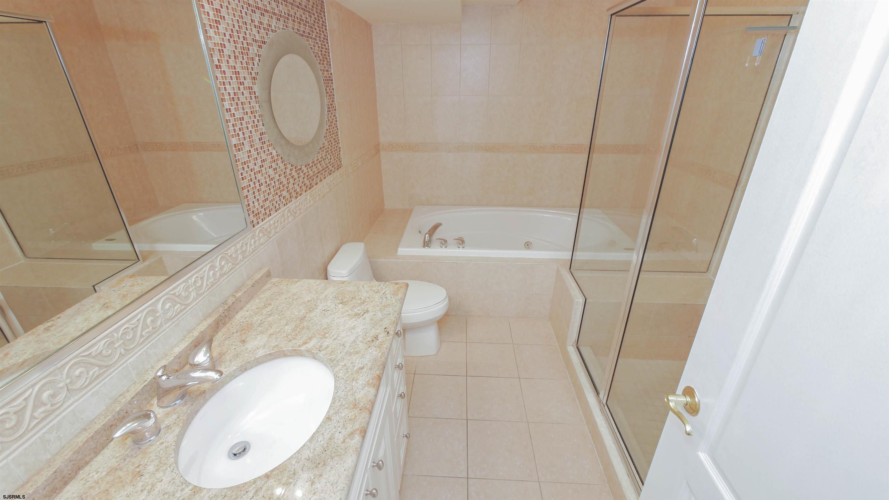137 South Berkley Square, Unit B Atlantic City, NJ 08401 - Photo 25 of 42 a bathroom with a granite countertop sink toilet and shower