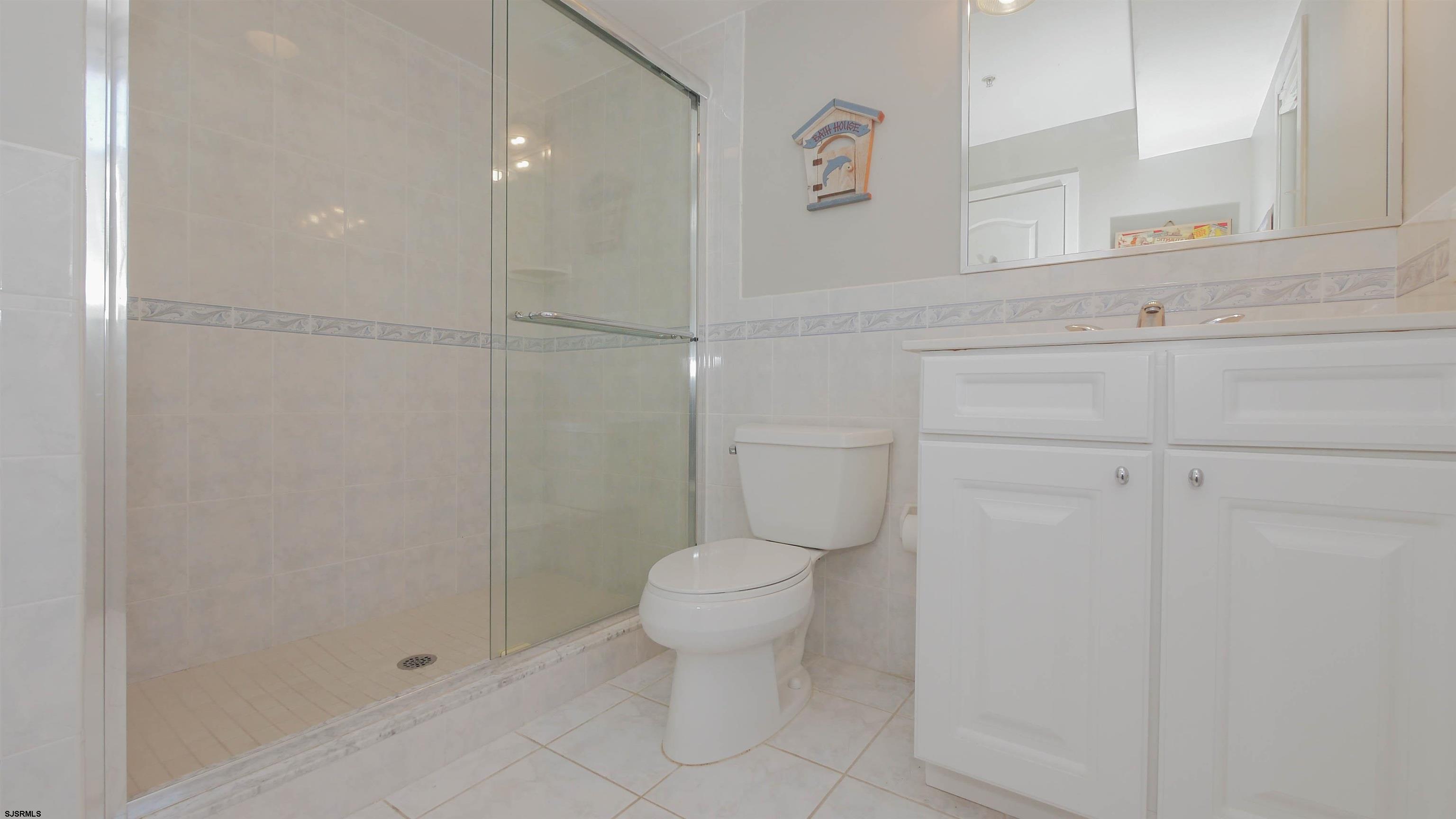 137 South Berkley Square, Unit B Atlantic City, NJ 08401 - Photo 29 of 42 a bathroom with a toilet sink and vanity