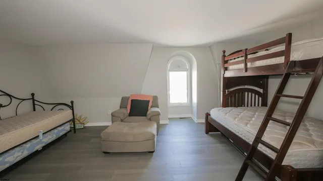 a bedroom with furniture and a window