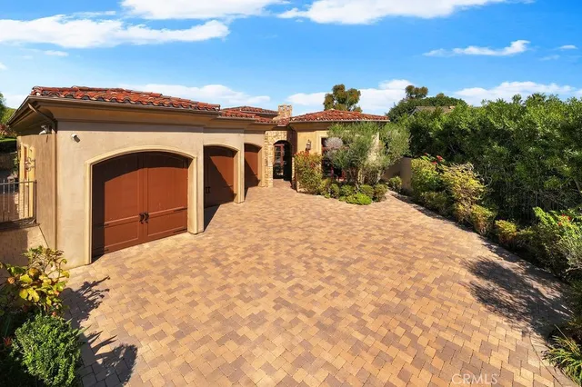 a view of a grey house with a yard