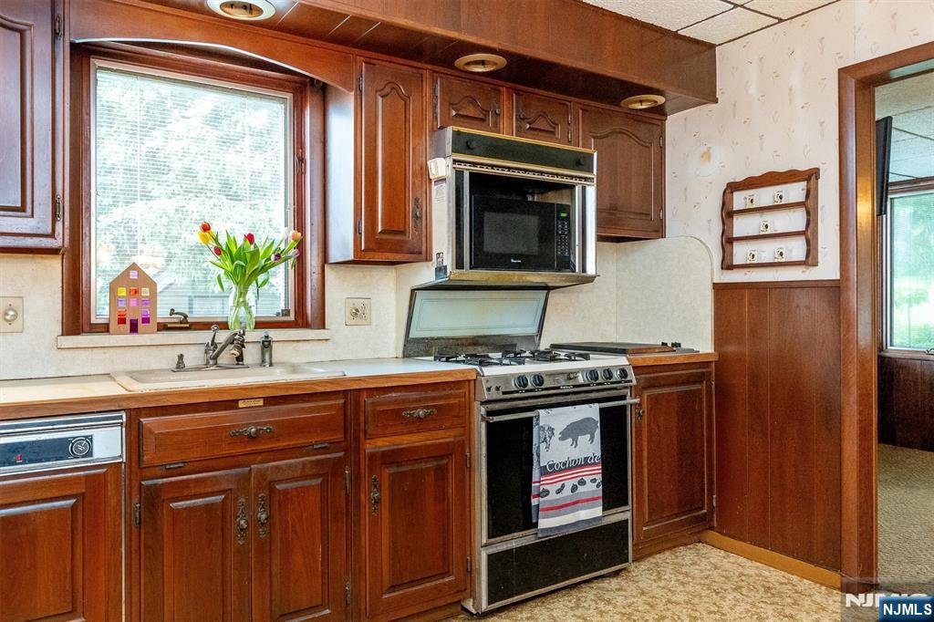 66 Coeyman Avenue Bloomfield, NJ 07003 - Photo 7 of 29 a kitchen with stainless steel appliances a stove sink and microwave