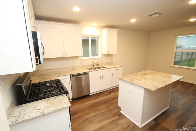 a kitchen with a stove and a sink