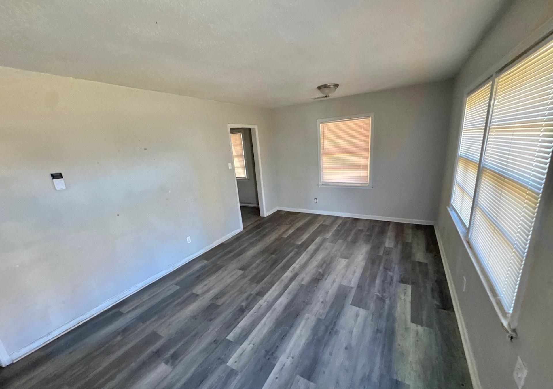 4826 Leonard Road Memphis, TN 38109 - Photo 4 of 8 Empty room with dark wood finished floors and baseboards