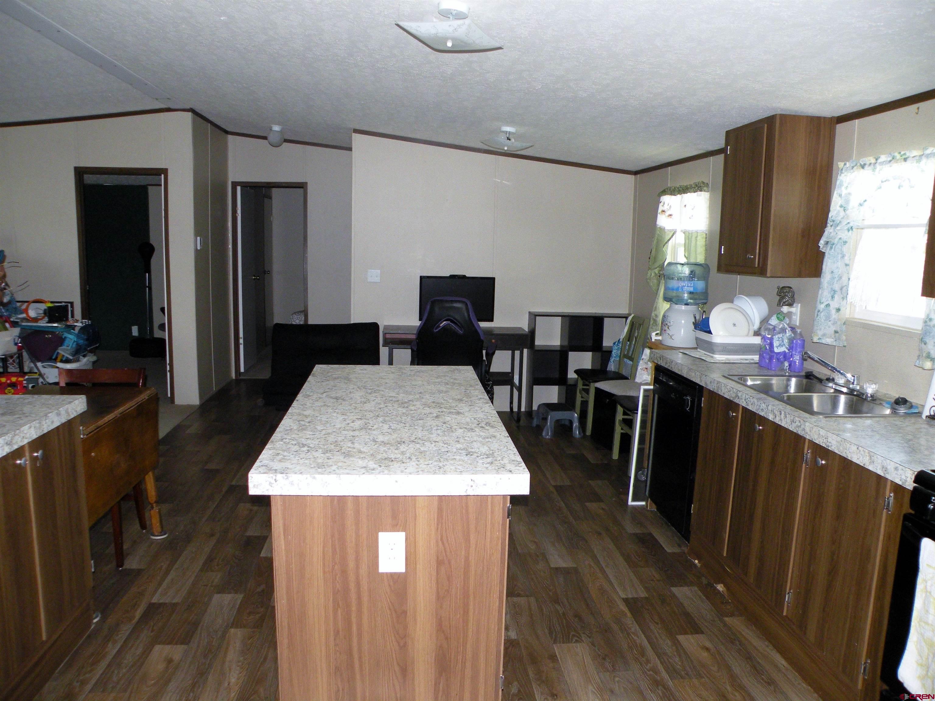 27936 CC Road Nucla, CO 81424 - Photo 2 of 10 a kitchen with sink a counter top space and wooden floor