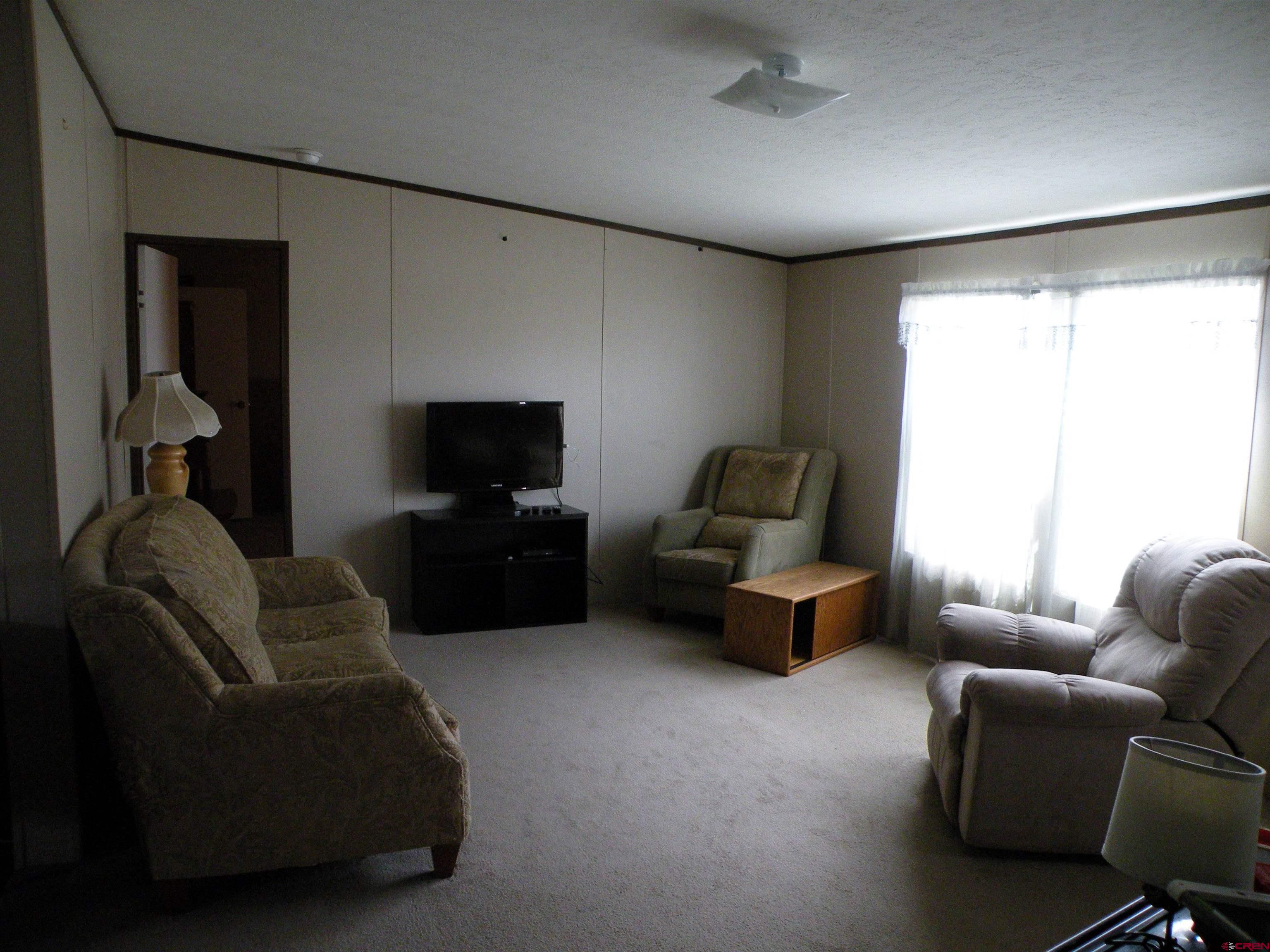27936 CC Road Nucla, CO 81424 - Photo 3 of 10 a living room with furniture and a flat screen tv