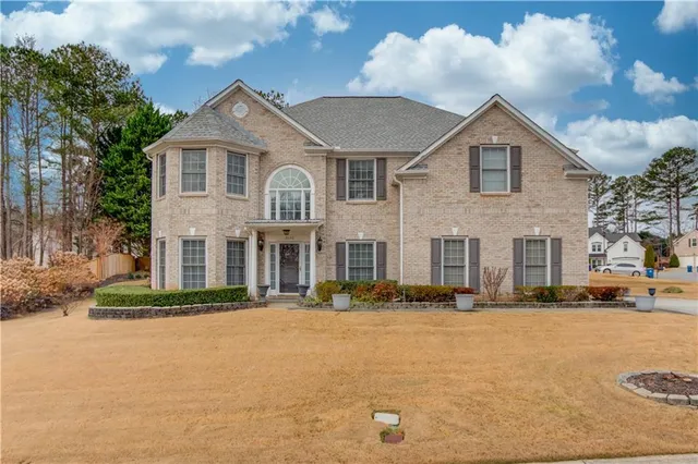 a front view of a house with a yard
