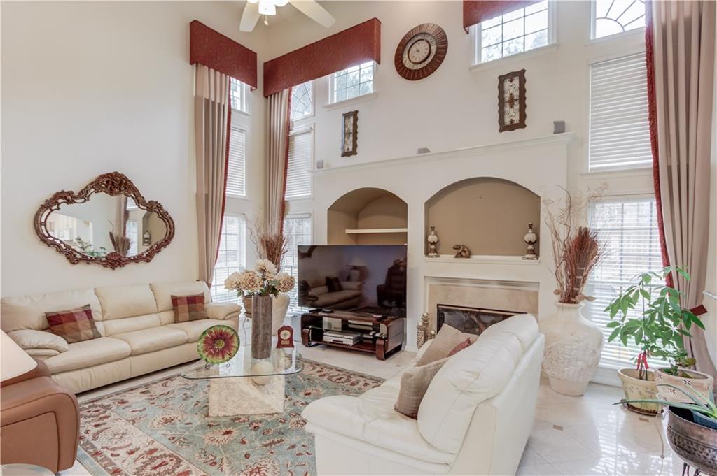 2648 Stockbridge Way Dacula, GA 30019 - Photo 12 of 59 a living room with furniture and a fireplace