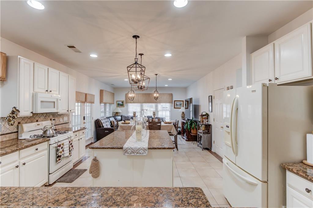 2648 Stockbridge Way Dacula, GA 30019 - Photo 16 of 59 a view of a kitchen with refrigerator and cabinets