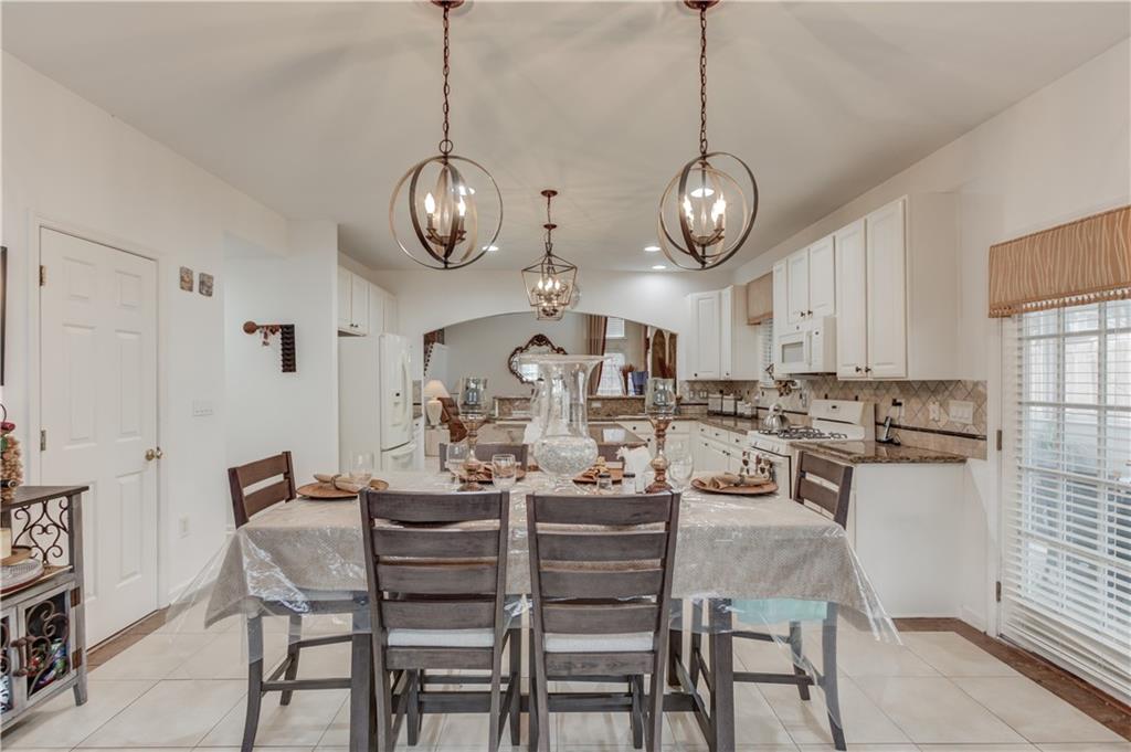 2648 Stockbridge Way Dacula, GA 30019 - Photo 21 of 59 a view of a dining room with furniture wooden floor and a chandelier