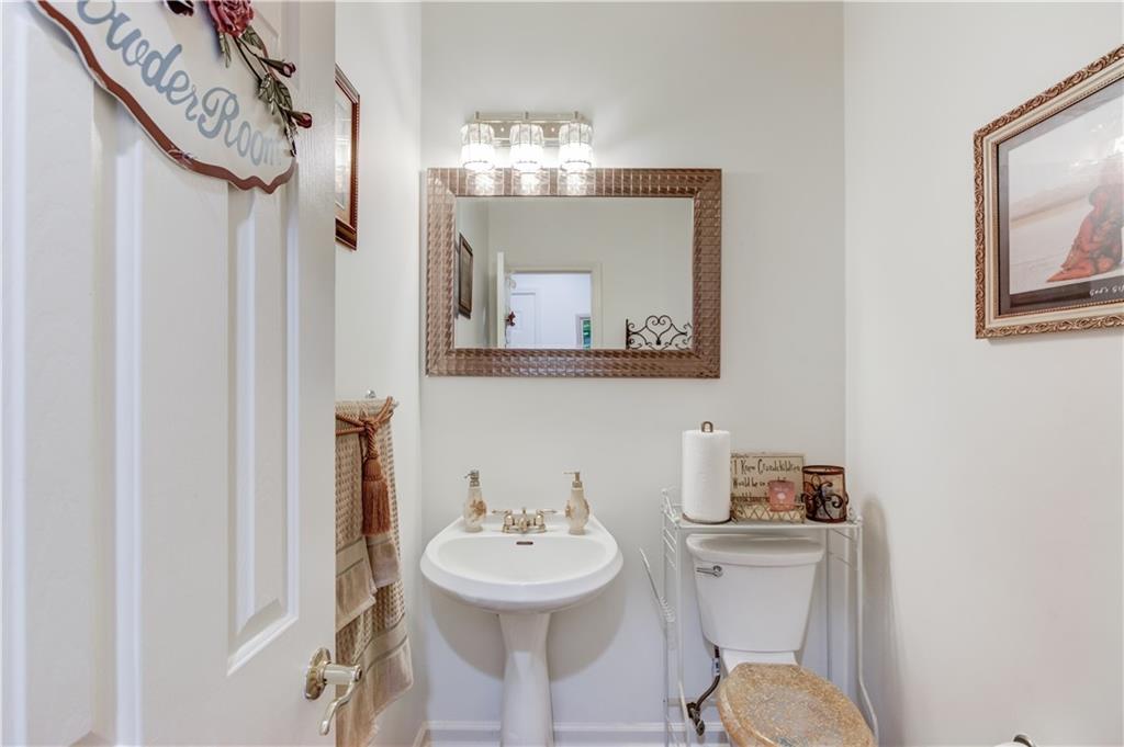 2648 Stockbridge Way Dacula, GA 30019 - Photo 23 of 59 a bathroom with a sink a mirror and a toilet