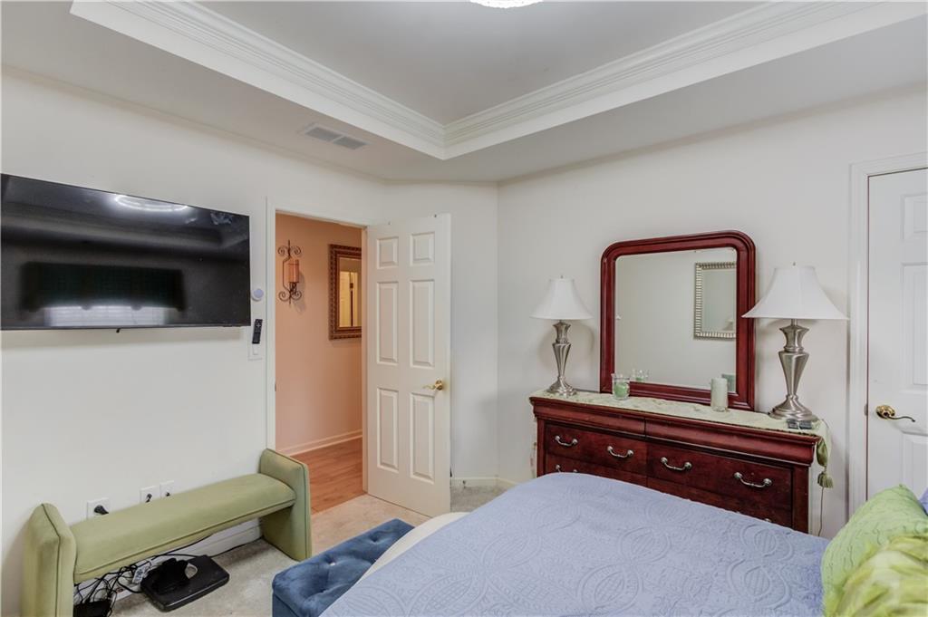 2648 Stockbridge Way Dacula, GA 30019 - Photo 43 of 59 a bedroom with a bed and a television