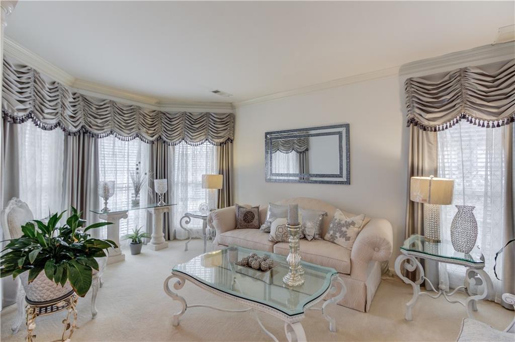2648 Stockbridge Way Dacula, GA 30019 - Photo 8 of 59 a living room with furniture a chandelier and a window