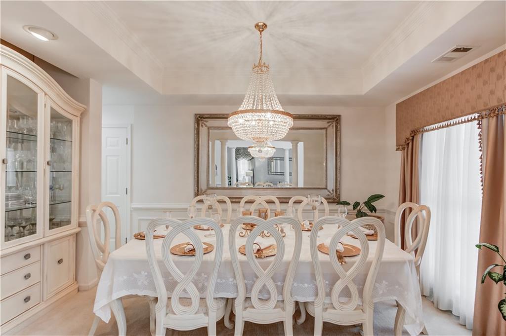 2648 Stockbridge Way Dacula, GA 30019 - Photo 10 of 59 a view of a dining room with furniture and chandelier