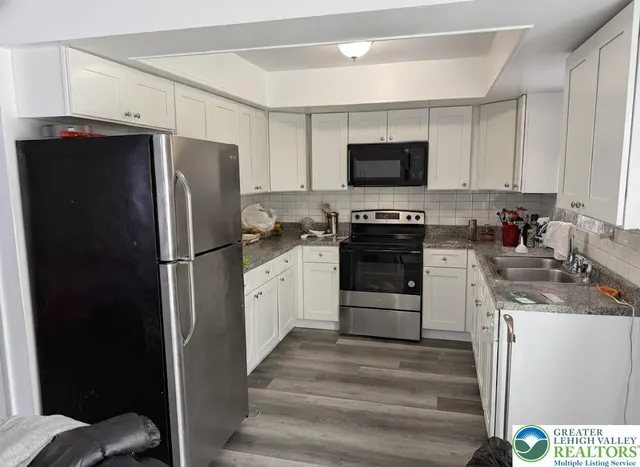 a kitchen with a refrigerator stove and sink