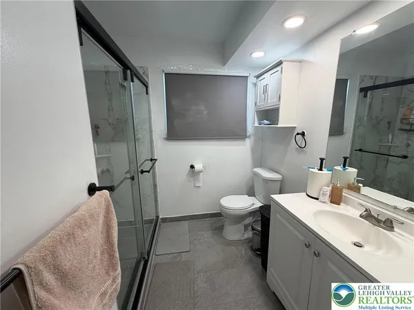 a bathroom with a sink and mirror with toilet