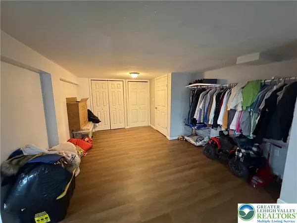 a view of a livingroom with furniture and clothes