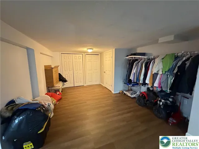 a view of a livingroom with furniture and clothes