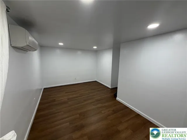 a view of a room with wooden floor