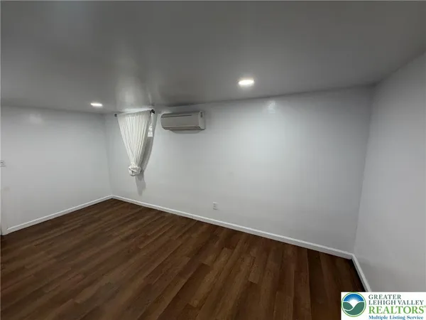 a view of room with wooden floor