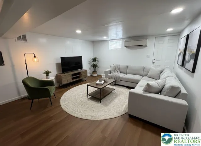 a living room with furniture and a flat screen tv