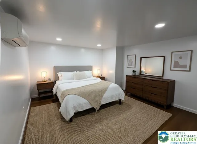 a bedroom with a bed and wooden floor